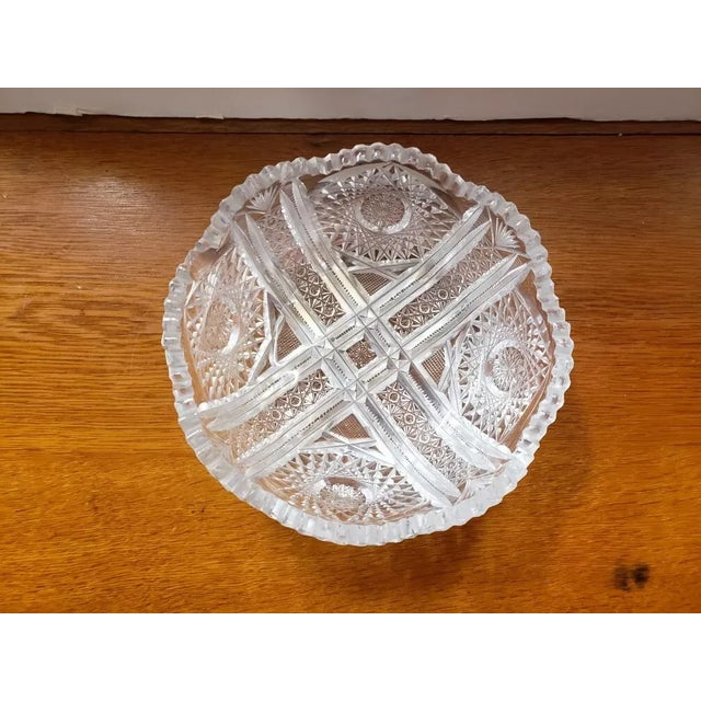 This is a Vintage Clear Cut Glass Sawtooth Rim Serving Bowl. It measures 3 1/4" high and 8 1/4“ in diameter. The piece is...