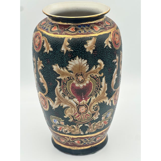 This vintage Chinese decorative porcelain vase (circa 1970s–1990s) features an ornate famille noire–inspired design with...
