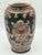 This vintage Chinese decorative porcelain vase (circa 1970s–1990s) features an ornate famille noire–inspired design with...