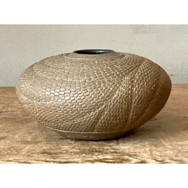 Immerse your interiors in the tactile allure of the natural world with this exquisite vintage studio pottery vase....