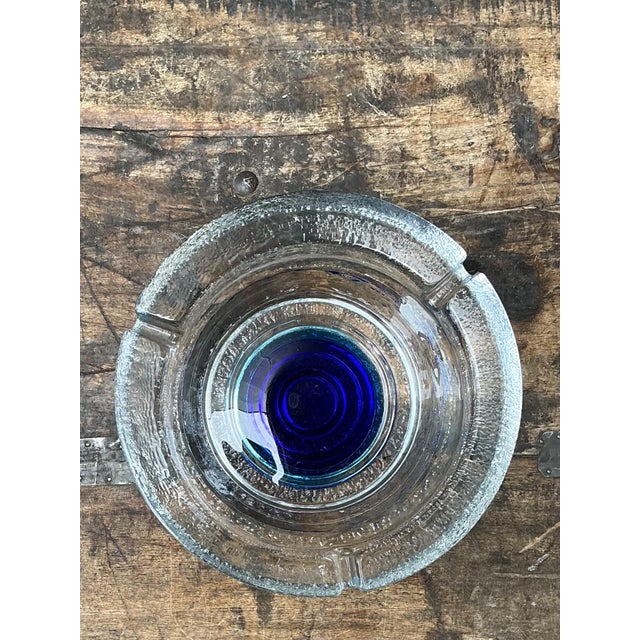 A striking example of Mid-Century Modern design, this vintage clear glass ashtray embodies the era's appreciation for...