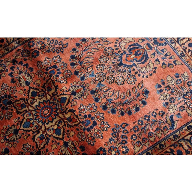 Handmade antique Persian Sarouk rug in original good condition. The rug is from the beginning of 20th century made in red...