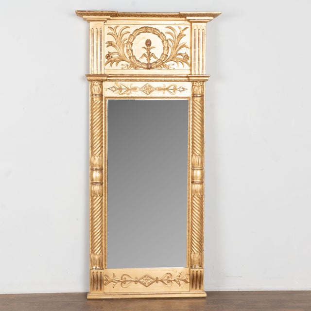 Early 19th century Swedish mirror crafted in giltwood with a richly aged gold gilt finish showing subtle burgundy...