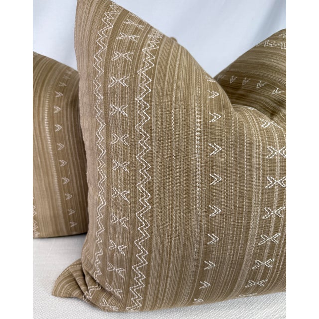 Custom pair of 22" pillows covered in Thibaut "Charter Stripe Embroidery" in color camel. These pillows have tapered...
