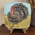 The Zrike on The Farm Italy Hand Painted Square Turkey Dish is a unique and decorative dish featuring a charming "on the...