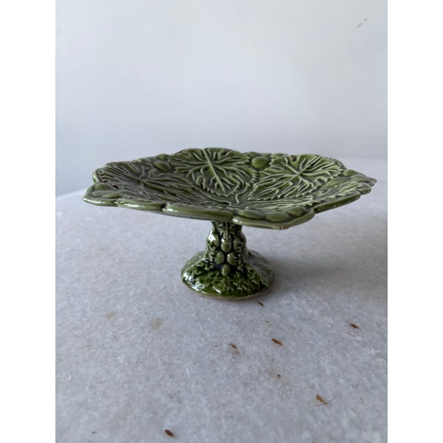 Green majolica footed pedestal desert plate featuring a cabbage leaf pattern