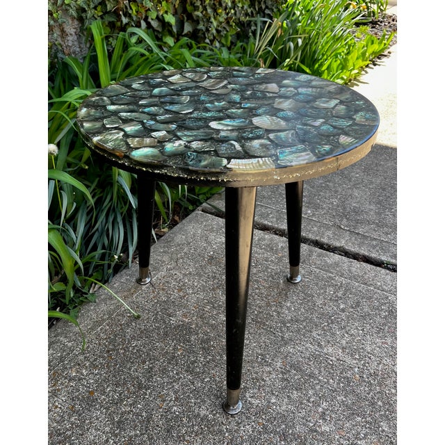 Gorgeous side table with polished abalone embedded in a clear resin. The top is on a tripod base. The legs will be...
