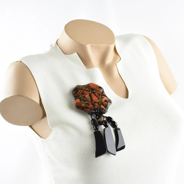 This is part of Chairish’s Costume Jewelry assortment. An impressive Lucite or resin pin brooch designed by Anne and Frank...