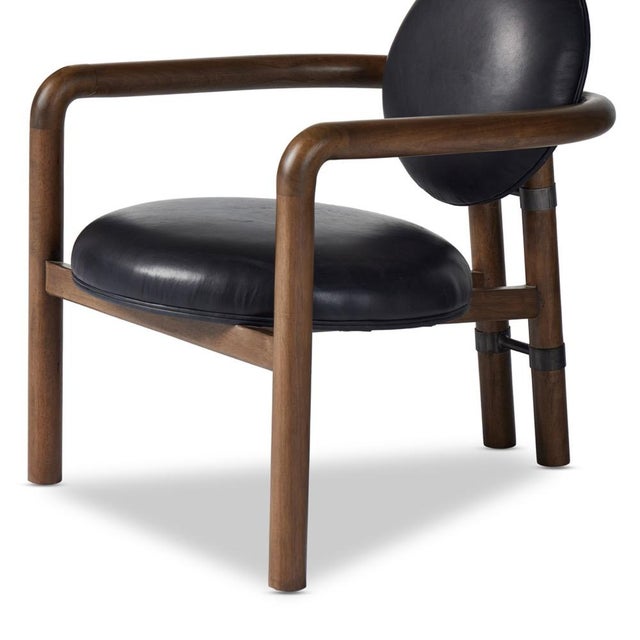 A playful take on Italian modernism. Solid parawood crafts a slim, curved frame and rear mock-tripod. Upholstered in black...