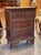 A small and characterful 18th century Italian commode with three drawers, each front decorated with geometric inlay in a...