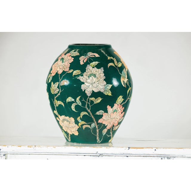This vibrant green ceramic vase features an enchanting composition of hand-painted birds, butterflies, and large blooming...