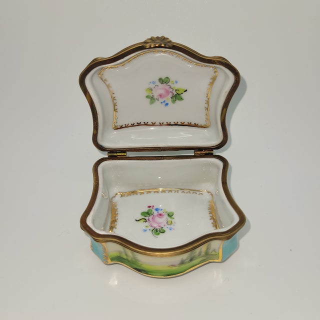 Beautiful antique Limoges porcelain trinket box. Main colors are robin’s egg blue and white with a lovely pastoral design....