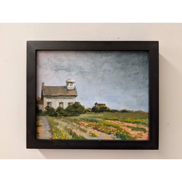 This oil on panel artwork depicts a quaint church nestled in a vibrant landscape, suggesting a serene escape. The soft,...