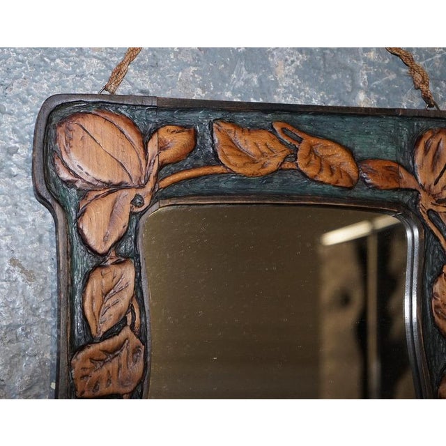 A beautiful antique French Art Nouveau wall mirror, richly carved with elegant floral decoration and graceful flowing...