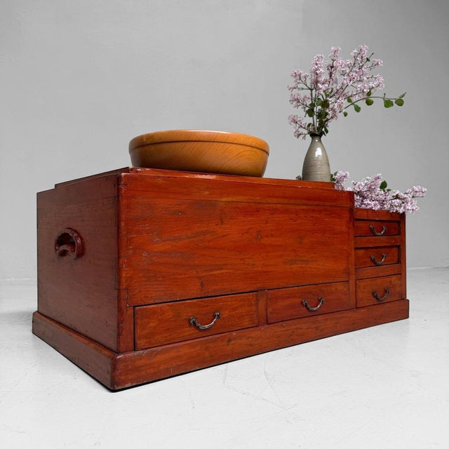 An exceptional Japanese hibachi cabinet with a warm reddish-brown wood tone, zinc-lined fire compartment, five drawers and...