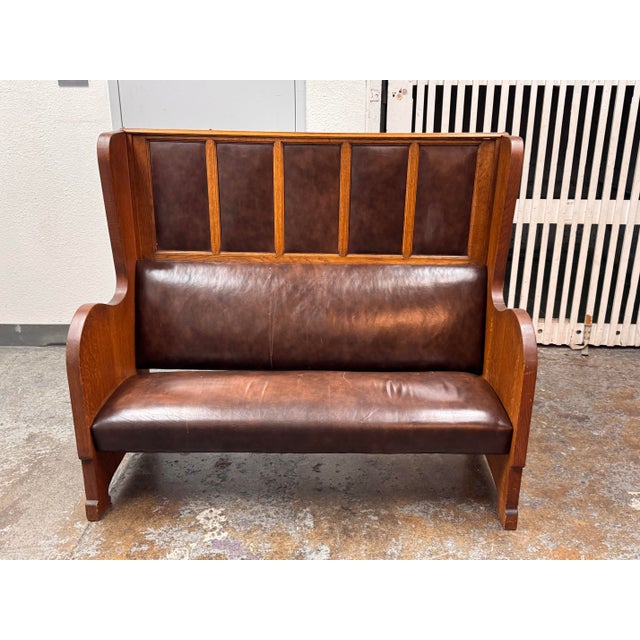 Design Plus Gallery presents an Antique High-Back Oak Settle Bench. This antique bench has an oak frame with a high...