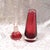 This is a pink art glass perfume bottle that has no tags or markings. The bottle is cone shaped dark pink cased in clear...