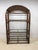 Very nice Genuine Ratan etagere with glass shelves. Piece has a wonderful almost fan style arched top with glass shelves....