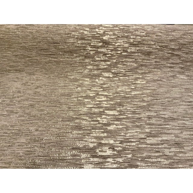 This modern abstract fabric has a course hand. The base cloth is silver with a thick gray slub design. This fabric is...