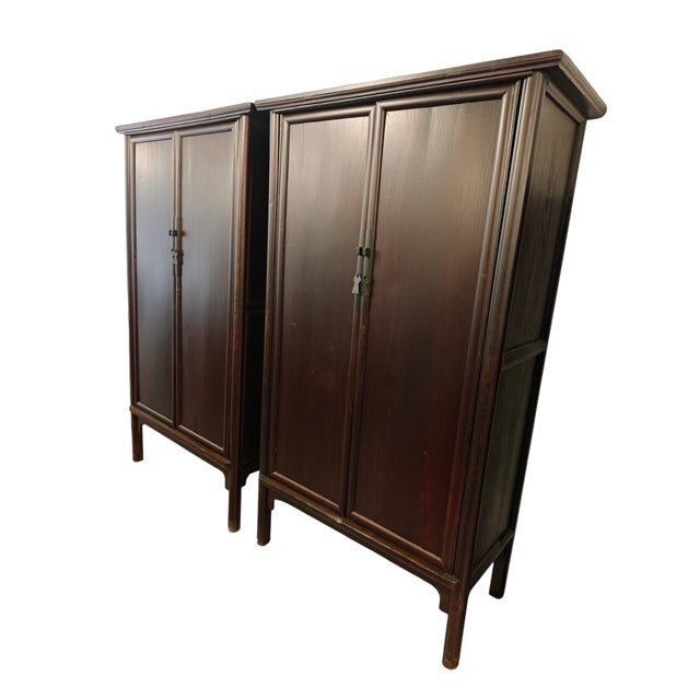 This pair of 19th century antique cabinets feature a clean-lined design with a rich, dark brown finish that highlights the...