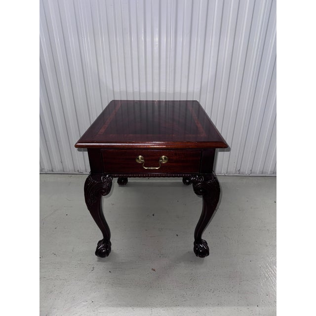 Matched pair of genuine Thomasville brand Chippendale-style end tables in stunning flame mahogany with satinwood...