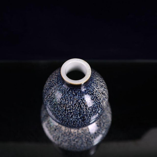 This elegant gourd-shaped ceramic vase features striking blue kiln transformation glaze with natural speckled texture,...