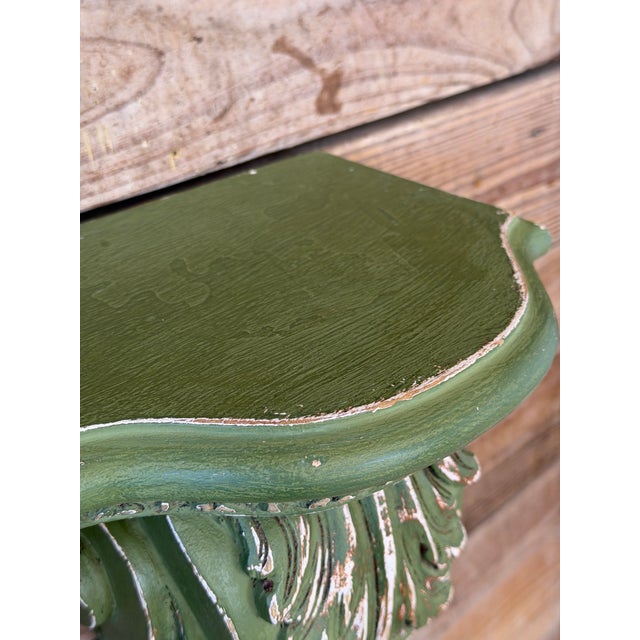 A striking pair of carved wall bracket shelves featuring classical acanthus leaf and scroll detailing in a beautifully...