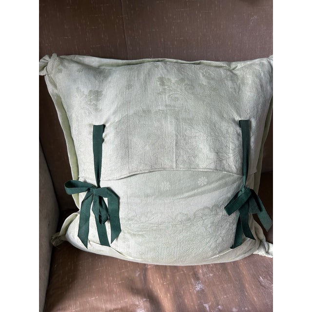 A pillow made with an early 20th century English printed linen, featuring a charming flora and fauna motif. A down insert...