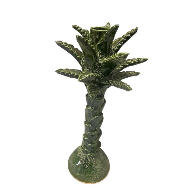 Add a touch of lush, tropical flair to your mantle or tablescape with this exquisite palm tree candle holder. Hand-...