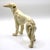 An elegant and sleek mid-century modern ceramic figurine depicting a standing greyhound or whippet. The sculpture features...