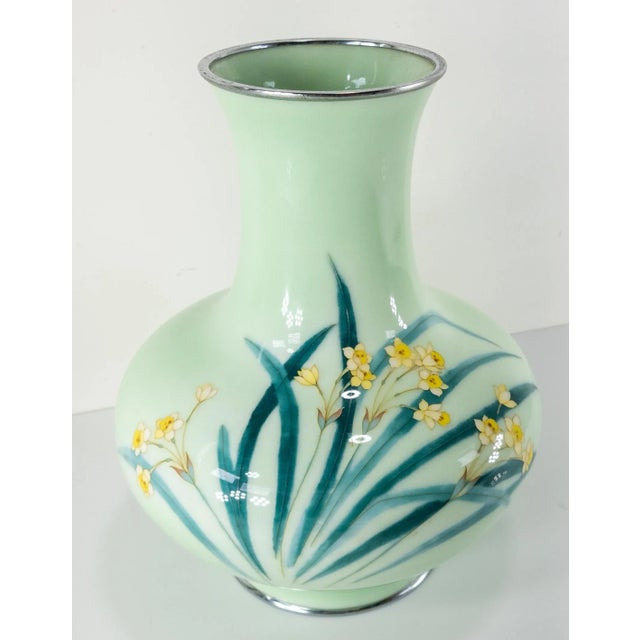 We are selling this stunning vintage Japanese cloisonne vase. This beautiful vase is decorated with narcissus or daffodil...
