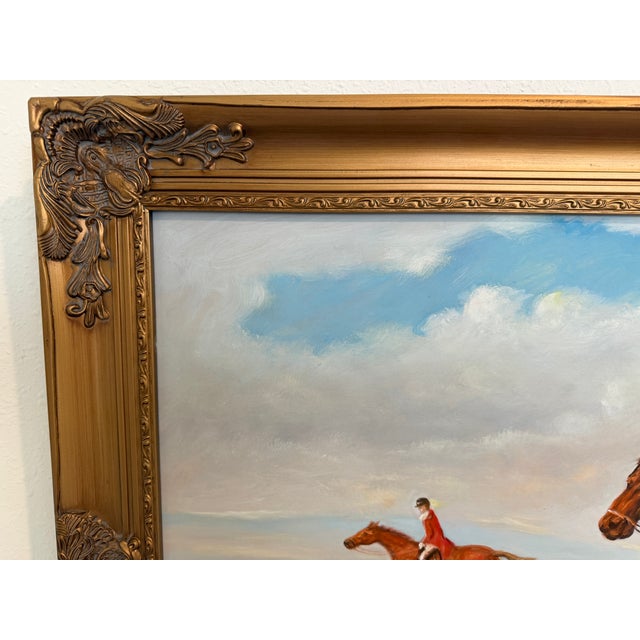 This large oil on canvas depicts a classic English fox hunting scene featuring mounted riders in traditional red coats...