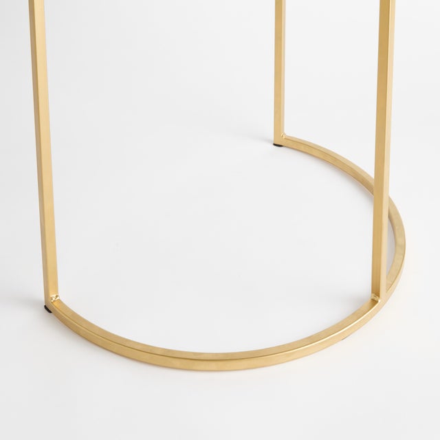 A simple mix ofWhite marble and brass creates a sophisticated look. A petite design, with a demilune silhouette, this...