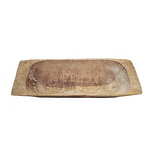 A vintage Tanzanian wooden trough, circa 1940. Hand-carved out of blonde wood. Contains a metal patch. Can be used as an...