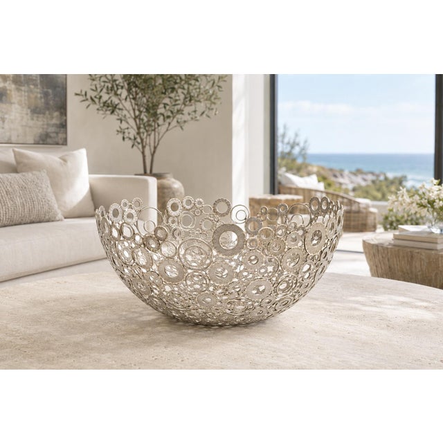A striking large-scale sculptural centerpiece bowl featuring an intricate openwork composition of layered circular metal...