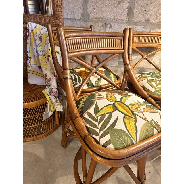 A pair of vintage bamboo counter stools with quiet colonial confidence. The cross-back silhouette and carved reed...