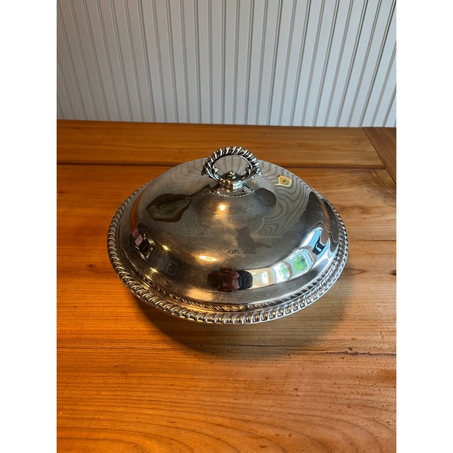 WM Rogers Mid-Century Round Silver Plated Covered Casserole Dish that balances refined simplicity with traditional...
