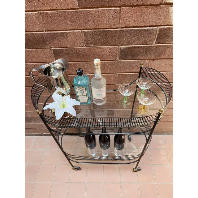 Vintage Mid Century Metal Bar Cart. Stylish kidney shaped two tiered design complete with smooth rolling wheels and acorn...