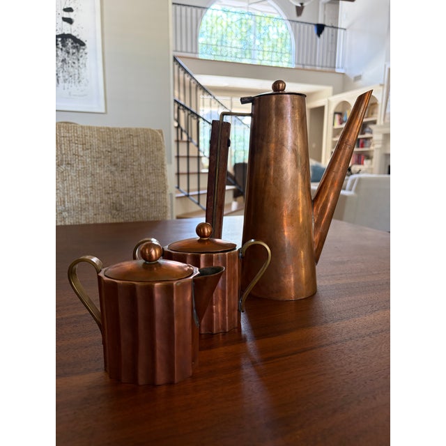 An exceptional handcrafted Mid-Century Modern copper coffee service consisting of a sculptural coffee pot, matching...