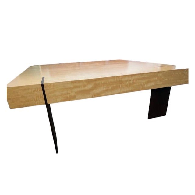 This architectural coffee table exhibits a signature element of Antoine Proulx design where the bronze metal legs pierce...