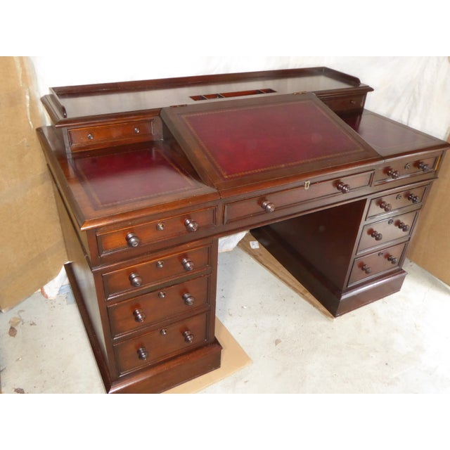 A superlative replica of THE Charles Dickens desk in solid mahogany. #82 - Dim.54 x 29 x 35.full ht. Writing surface 30''...
