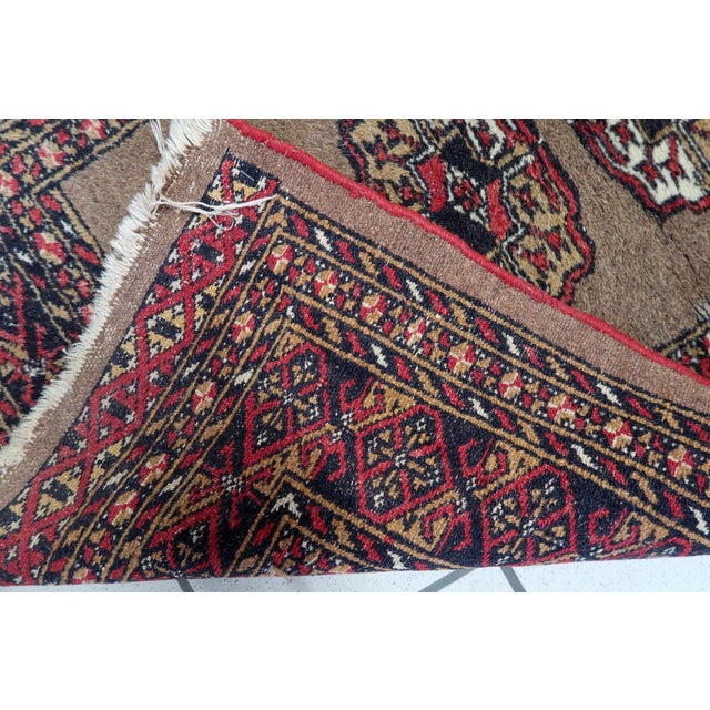An exquisite antique Uzbek Bukhara rug from the 1920s, showcasing the masterful geometric artistry of Central Asian tribal...