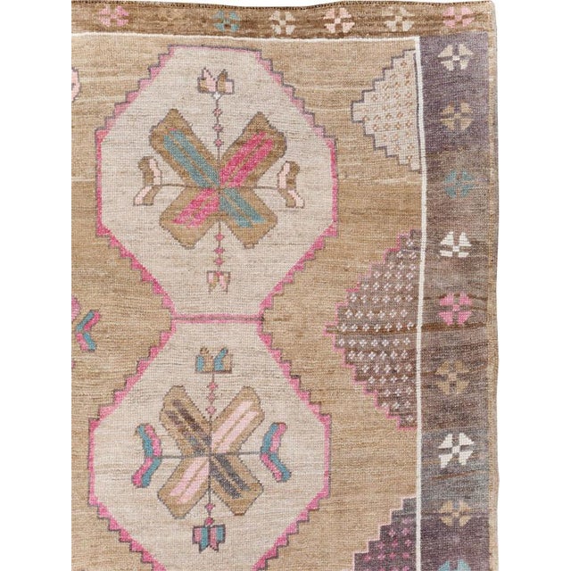 This mid-20th century Turkish Anatolian room-size carpet, is a beautifully expressive tribal weaving with a soft, luminous...
