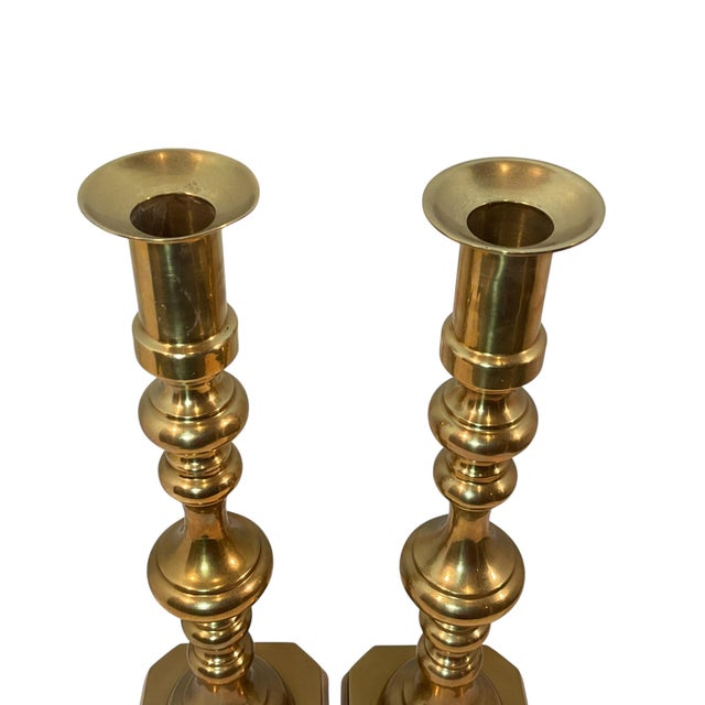 Two tall classic brass candlesticks. These candle holders will mix well with others. The candle port is 1 1/4” wide....