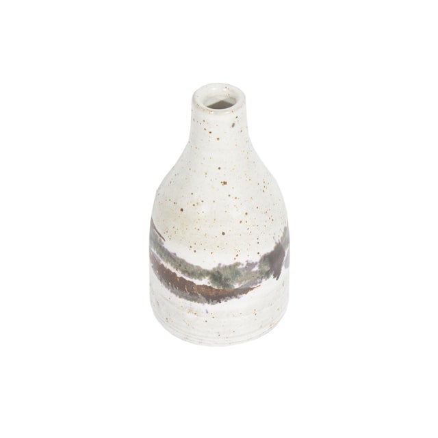 A studio pottery vase by Indiana artist Richard Peeler (1926-1998). This bottle-shaped vase has a narrow neck and a...