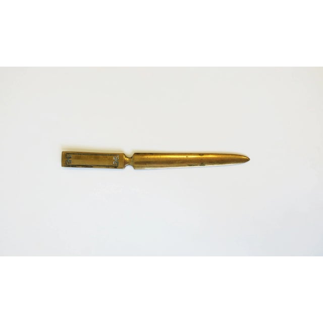A vintage brass letter opener with a Greek-Key like design on handle, circa 20th century. Dimensions: .63" W x 7.5" Long.