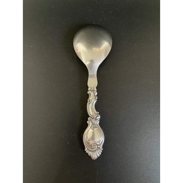 A vintage Danish silver serving spoon by Johannes Siggaard. This exquisite piece showcases stunning Rococo styling with...