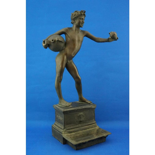 Wonderful, imposing sculpture in solid bronze, depicting a naked boy, with a vase and jug in his hand, standing above a...