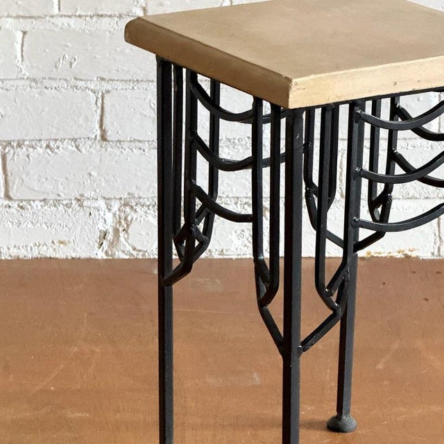 Bespoke structural black wrought iron table featuring a contrasting sandstone surface. Condition Vintage condition, some...