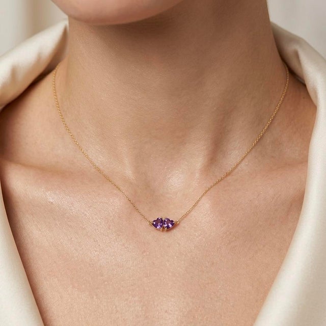 Add a touch of regal elegance to your jewelry collection with this romantic two-stone pendant necklace, featuring two...